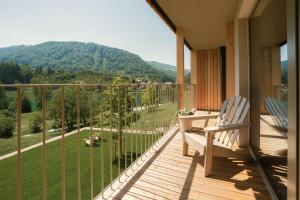 a balcony with a chair and a view of a mountain at Hotel Tulie in Most na Soči