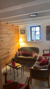 a living room with two couches and a table at Le cordonnier du Staedel in La Petite-Pierre