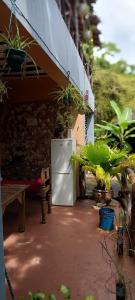 a white refrigerator sitting outside of a house with plants at Serene Apartments in Kinyasini +7 photos