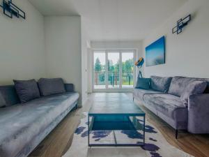 a living room with a couch and a coffee table at Apartment Pegasus by Salzkammergood Living in Tauplitz