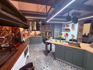 a kitchen with a counter and a table in it at Ateliér Kráľovič in Hokovce