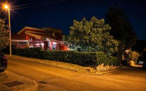 a street at night with a building and a street light at Polaroid House '76 in Radovici