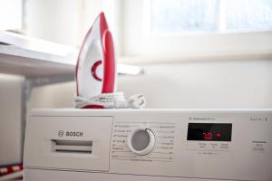 a microwave with a pair of scissors on top of it at Zaunkönigin in Norden