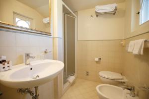 a bathroom with a sink and a toilet and a mirror at B&B Ortensia in Forte dei Marmi +33 photos