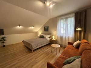a bedroom with a bed and a couch at Młyn Bosaka in Ojców