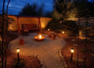 a garden with candles and a gazebo at night at Rezidence U Kapličky - stylové ubytování & privátní wellness - Adults Only in Uničov