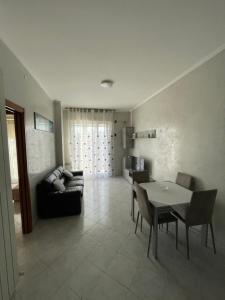 a living room with a table and a couch at Happy Oasi in Lido Adriano