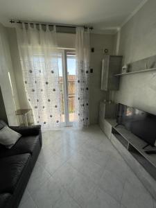 a living room with a couch and a fireplace at Happy Oasi in Lido Adriano +11 photos