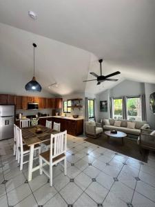 a kitchen and living room with a table and chairs at Private 2 Bedroom Home with Pool Near El Coco Beach in Coco