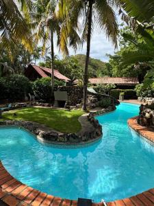 a swimming pool with blue water in a resort at Private 2 Bedroom Home with Pool Near El Coco Beach in Coco