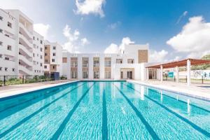 a swimming pool in front of a building at MO Buxton Lux Apartment- Mombasa CBD 70 in Frere Town