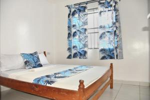 a bed in a room with blue and white curtains at MO Buxton Lux Apartment- Mombasa CBD 70 in Frere Town +18 photos