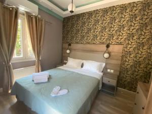 a bedroom with a bed with two slippers on it at Anaxos Garden in Anaxos +66 photos