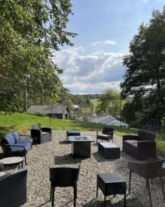 a group of chairs and tables in a yard at Shelburne Springs Hotel in Shelburne Falls