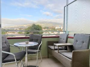 a balcony with chairs and a table and a view at Edificio Las Marañuelas, Puerto La Cruz, Islas Canarias Tenerife in Puerto de la Cruz