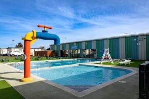 a pool with a water fountain in front of a building at Seawick Holiday Park in Jaywick Sands +3 photos