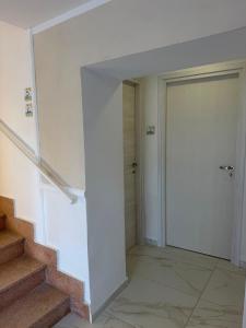a hallway with a door and stairs in a building at Mare D'amare in Diamante +9 photos
