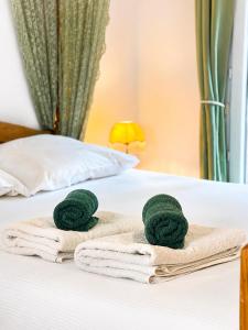 a couple of towels on a bed at Chalet Forestôchat in Tressé
