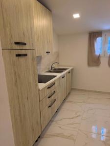 a kitchen with wooden cabinets and a sink at Mare D'amare in Diamante