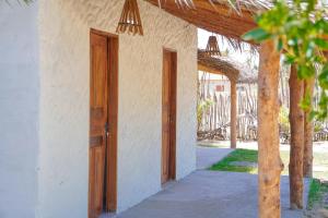 an open door of a building with a porch at Pousada vila jaguar - arpoador in Tutóia