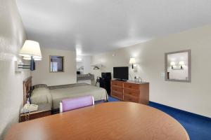 a hotel room with a bed and a table at Knights Inn Jacksonville at Dix Ellis Trail in Sunbeam