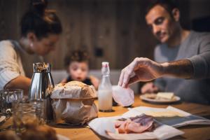 a man and woman sitting at a table eating food at Kessler's Mountain Lodge in Natz-Schabs