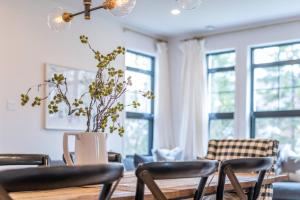 a dining room with a table and chairs and windows at Tremblant Prestige - Les Eaux 215-6 in Mont-Tremblant