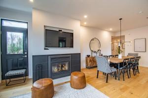 a dining room with a fireplace and a table and chairs at Tremblant Prestige - Les Eaux 215-6 in Mont-Tremblant