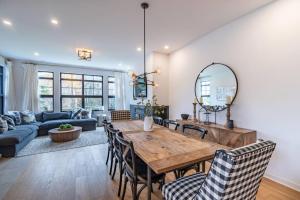 a living room with a wooden table and chairs at Tremblant Prestige - Les Eaux 215-6 in Mont-Tremblant +16 photos