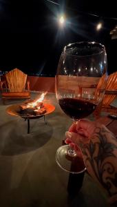 a person holding a glass of wine on a table at Casas 2 Terrace in Laguna