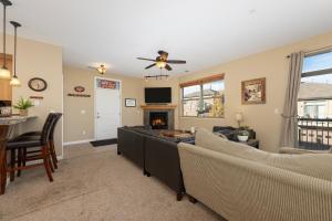 a living room with couches and a fireplace at Timbers 9-4 in Fraser