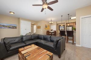 a living room with a black leather couch and a table at Timbers 9-4 in Fraser
