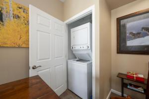 a white laundry room with a washer and dryer at Timbers 9-4 in Fraser