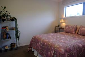 a bedroom with a bed and a window at Bordeaux Retreat in Te Kauwhata