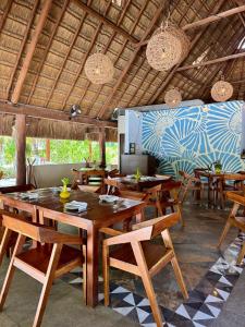 a dining room with wooden tables and chairs at Tecnohotel Beach in San Benito