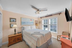 a bedroom with a bed and a television in it at Luxury Waterfront & Oceanfront Beach Paradise in North Topsail Beach