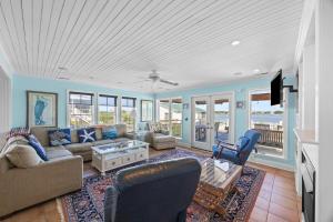 a living room with a couch and a table at Luxury Waterfront & Oceanfront Beach Paradise in North Topsail Beach