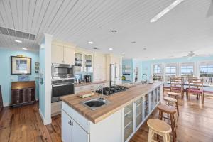 a kitchen with a sink and a counter top at Luxury Waterfront & Oceanfront Beach Paradise in North Topsail Beach