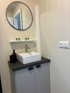 a bathroom with a sink and a mirror at Akrar guesthouse in Hella
