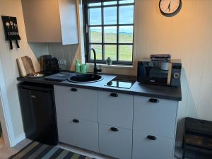 a kitchen with a counter top with a microwave at Akrar guesthouse in Hella