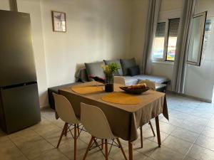 a living room with a table and a couch at Emari Apartments in Heraklio