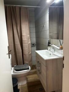 a bathroom with a toilet and a sink and a shower at Emari Apartments in Heraklio +15 photos