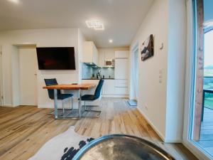 a kitchen and dining room with a table and chairs at Apartment Gemini by Salzkammergood Living in Tauplitz