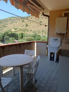 a table and chairs on a patio with a view of a mountain at Casa al Pozzarello in Porto Santo Stefano