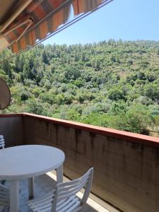 a table and chairs on a balcony with a view at Casa al Pozzarello in Porto Santo Stefano