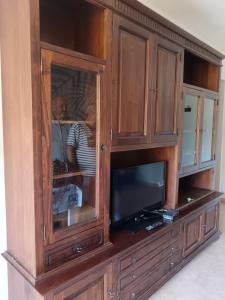 a wooden cabinet with a television in it at Casa al Pozzarello in Porto Santo Stefano +1 photo