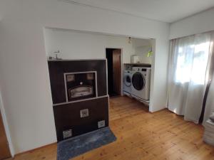 a living room with a washer and dryer at Happy place in Kitee