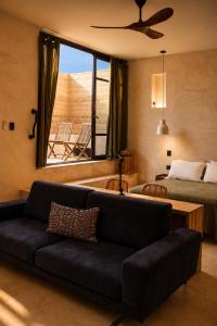 a living room with a couch and a bed and a window at Olivo Mio in La Paz +30 photos
