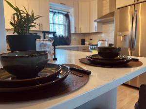 a kitchen with two plates and bowls on a counter at La Suite de Antonio Shared Property PRIVATE stay NYC 18mins in North Bergen