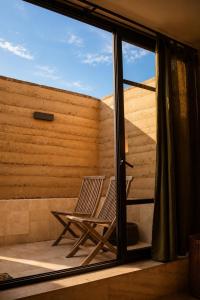 a pair of chairs sitting on the balcony of a house at Olivo Mio in La Paz